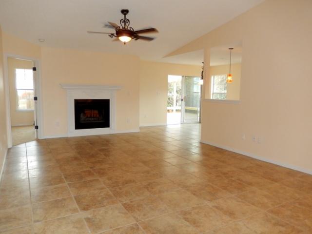 a view of a livingroom with a ceiling fan and window