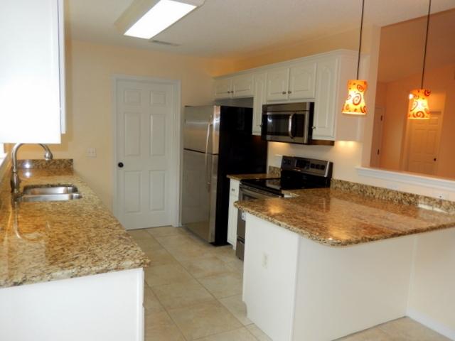 9 Stowe Road Mary Esther, FL 32569 - Photo 7 of 24 a kitchen with kitchen island granite countertop counter top space appliances and a counter top space