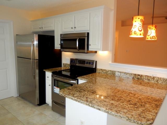 9 Stowe Road Mary Esther, FL 32569 - Photo 9 of 24 a kitchen with kitchen island a sink stainless steel appliances and cabinets