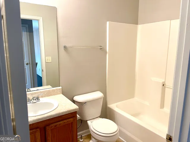 a white toilet sitting next to a bathroom sink