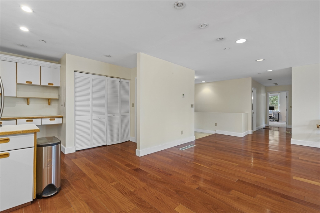 241 Perkins Street, Unit D405 Boston, MA 02130 - Photo 11 of 36 a view of a kitchen with wooden floor and a sink