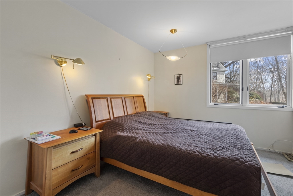 241 Perkins Street, Unit D405 Boston, MA 02130 - Photo 14 of 36 a bedroom with a bed and a window