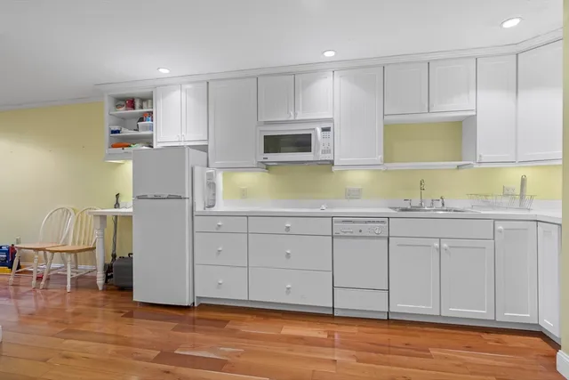 a kitchen with sink cabinets and wooden floor