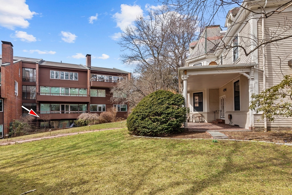 241 Perkins Street, Unit D405 Boston, MA 02130 - Photo 30 of 36 a view of a house with floor to ceiling windows and a basket ball poll