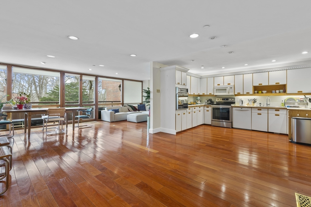 241 Perkins Street, Unit D405 Boston, MA 02130 - Photo 3 of 36 a view of a kitchen with dining room and wooden floor