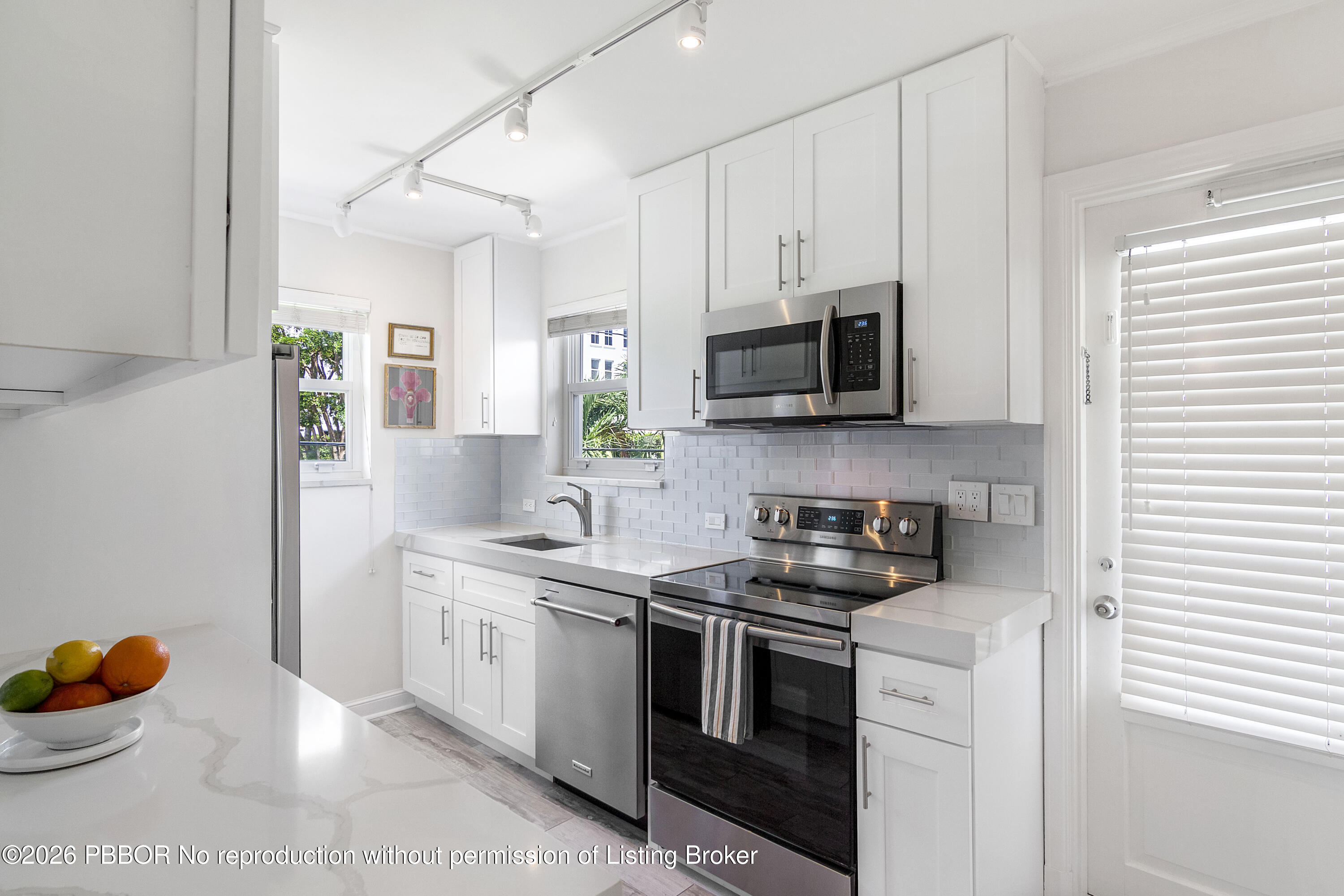 311 Cocoanut Row, Unit 201 Palm Beach, FL 33480 - Photo 10 of 12 a kitchen with stainless steel appliances granite countertop a sink and a stove