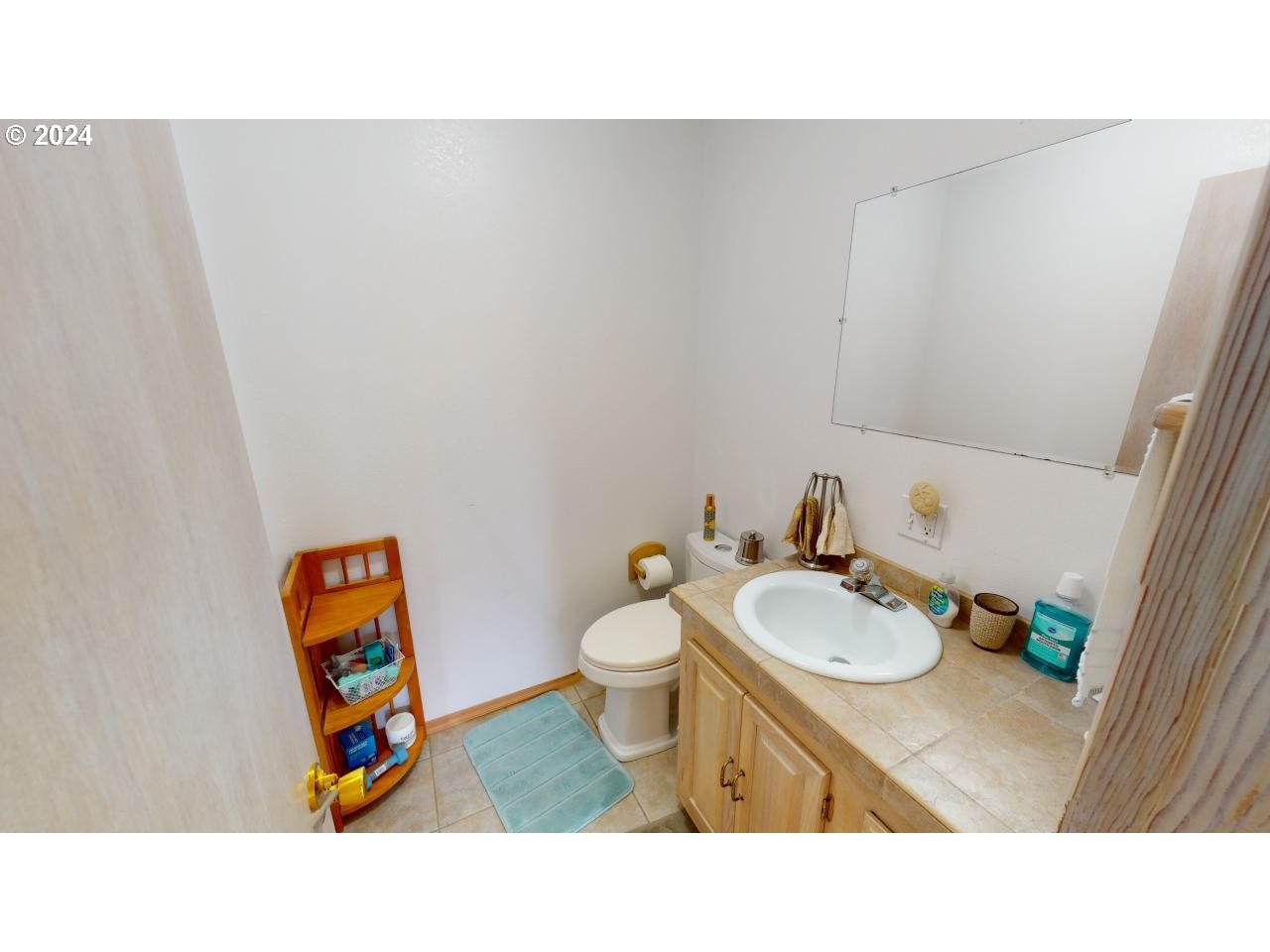 33327 Ophir Road Gold Beach, OR 97444 - Photo 15 of 32 a bathroom with a sink a toilet and a mirror