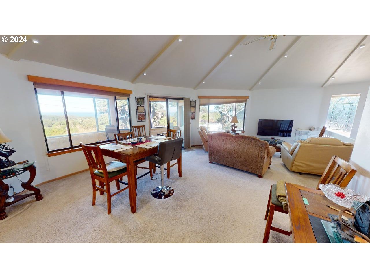 33327 Ophir Road Gold Beach, OR 97444 - Photo 5 of 32 a living room with furniture a flat screen tv and a large window