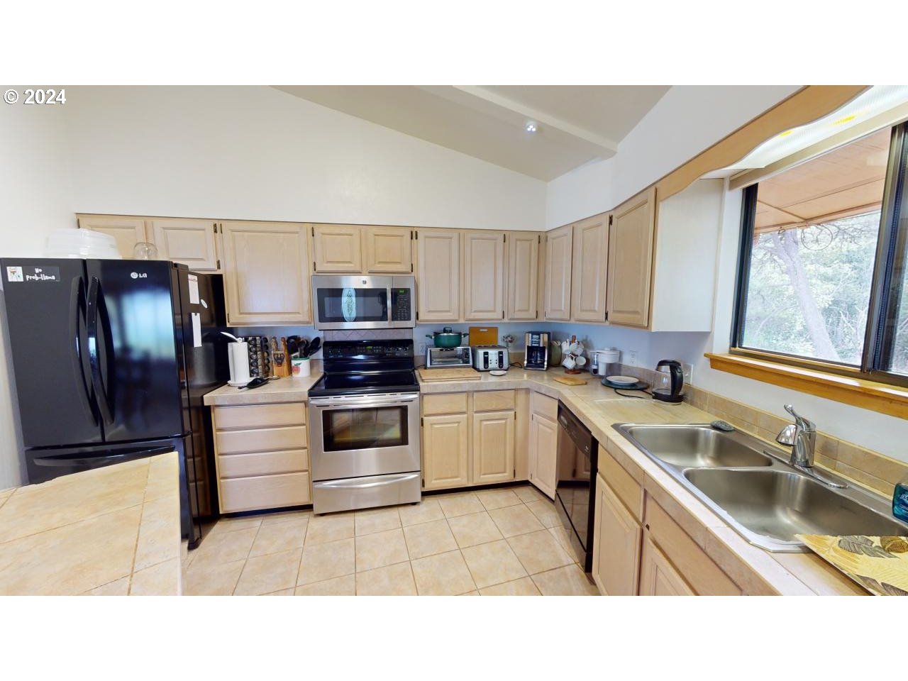 33327 Ophir Road Gold Beach, OR 97444 - Photo 10 of 32 a kitchen with stainless steel appliances granite countertop a sink stove and refrigerator