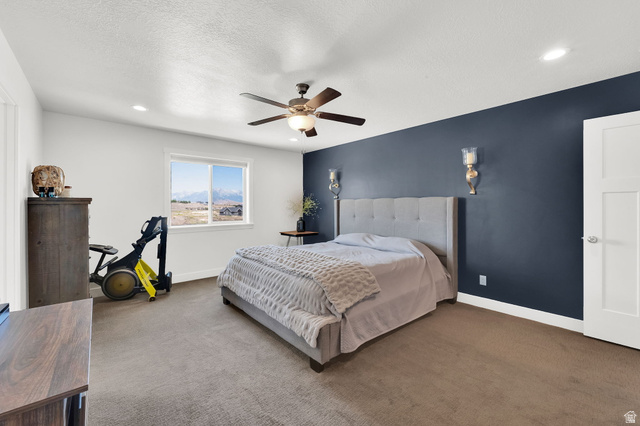 1857 Thunder Gulch Road Eagle Mountain, UT 84005 - Photo 21 of 50 Carpeted room featuring a window with expansive distant scenery, a ceiling fan with integrated lighting, and recessed ceiling lighting