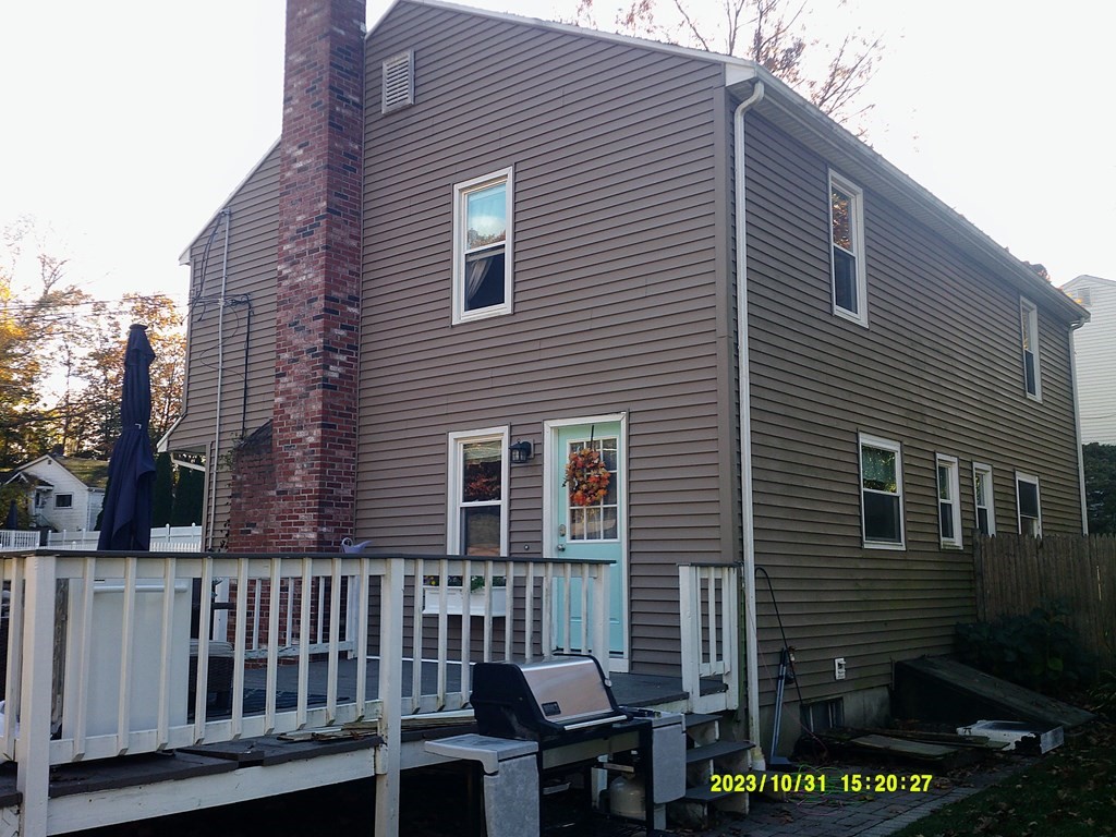 77 Indian Run Road, Unit 77 Bellingham, MA 02019 - Photo 3 of 18 a view of a house with a small yard and wooden fence