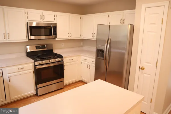 a kitchen with a refrigerator stove and microwave