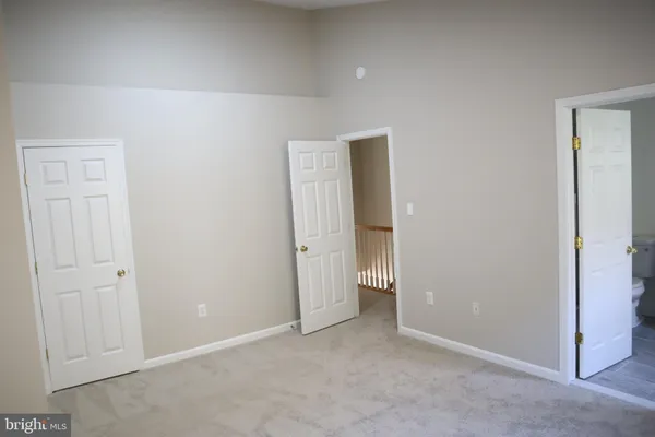 an empty room with closet area