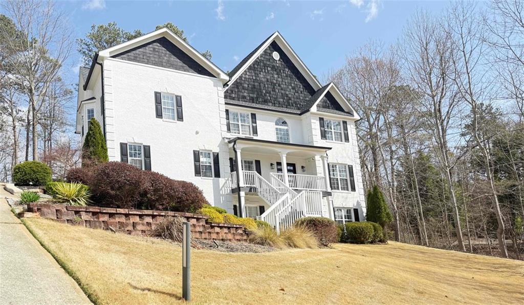 1046 Wiley Bridge Road Woodstock, GA 30188 - Photo 2 of 4 a front view of a house with a yard