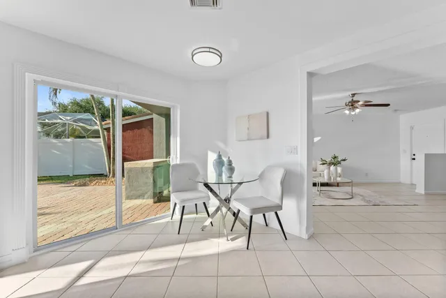 a dining room with furniture and window