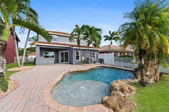 a view of a house with a yard and a garden