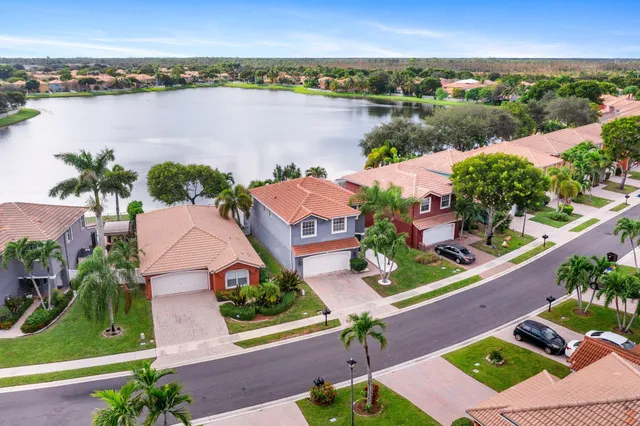 an aerial view of house with yard and ocean view