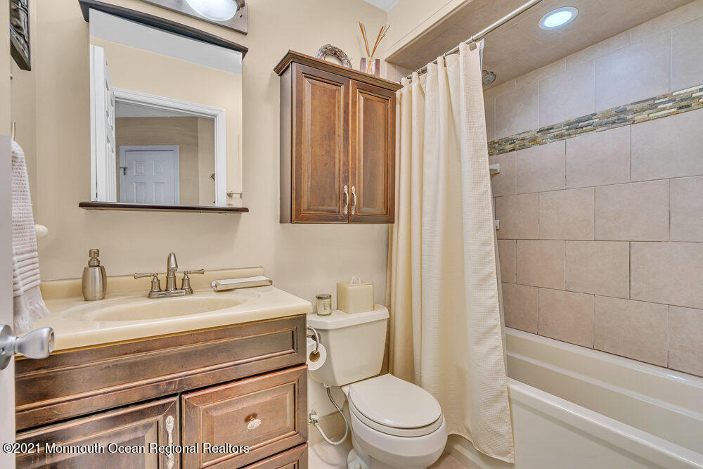 39 Bramble Lane Matawan, NJ 07747 - Photo 17 of 28 a bathroom with a granite countertop toilet sink and mirror