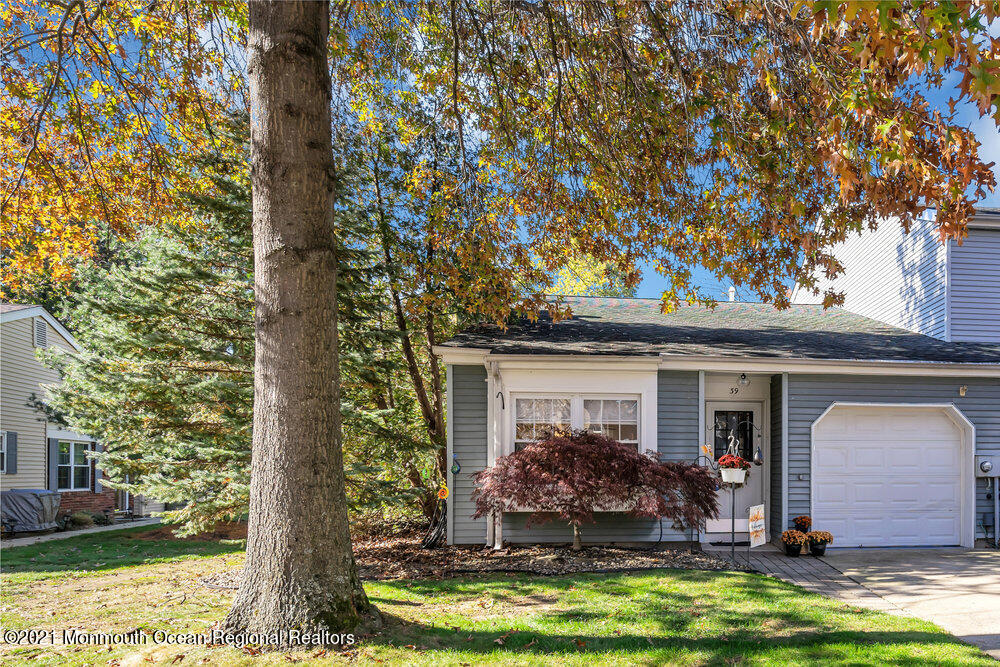 39 Bramble Lane Matawan, NJ 07747 - Photo 3 of 28 a view of house with yard outdoor seating and covered with plants