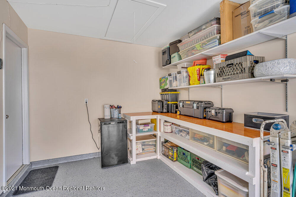 39 Bramble Lane Matawan, NJ 07747 - Photo 26 of 28 a kitchen with stainless steel appliances granite countertop a lot of cabinets and empty racks