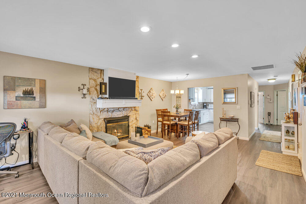 39 Bramble Lane Matawan, NJ 07747 - Photo 4 of 28 a living room with furniture a fireplace and a flat screen tv