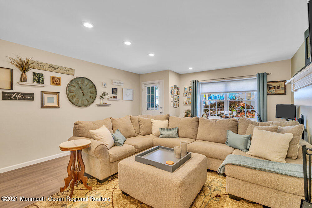 39 Bramble Lane Matawan, NJ 07747 - Photo 6 of 28 a living room with furniture a clock on wall and a window