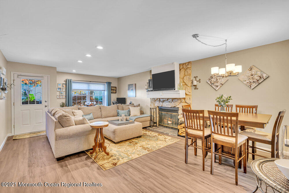 39 Bramble Lane Matawan, NJ 07747 - Photo 7 of 28 a living room with furniture fireplace and a flat screen tv