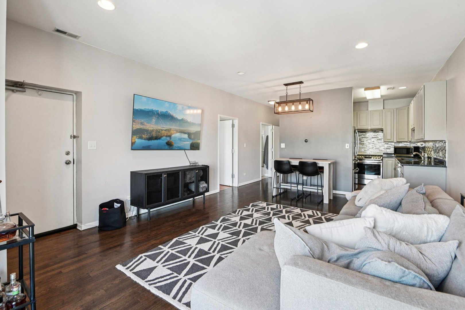 828 West 31st Street, Unit 3N Chicago, IL 60608 - Photo 3 of 29 a living room with furniture a flat screen tv and a fireplace