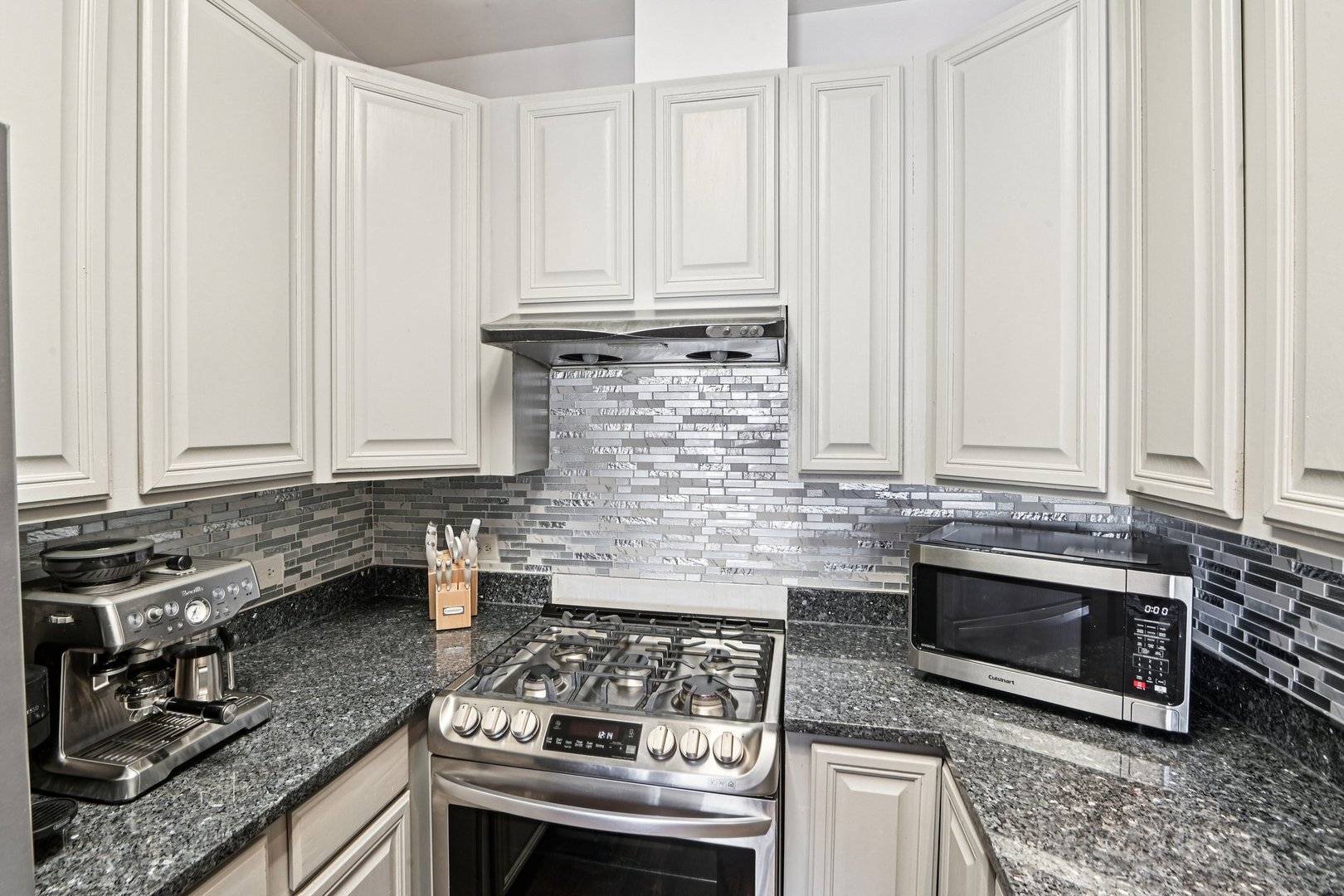 828 West 31st Street, Unit 3N Chicago, IL 60608 - Photo 10 of 29 a kitchen with granite countertop a stove sink and cabinets