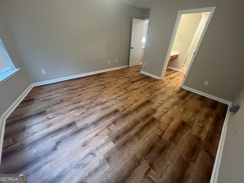 95 Creek Way Covington, GA 30016 - Photo 14 of 25 a view of an empty room with wooden floor