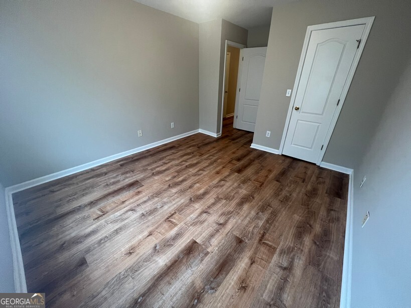 95 Creek Way Covington, GA 30016 - Photo 19 of 25 an empty room with wooden floor