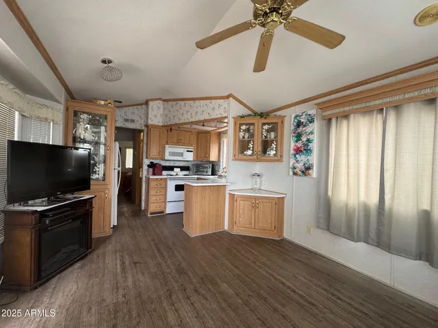 a open kitchen with cabinets a stove and a refrigerator