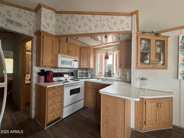 a kitchen with a stove top oven sink and cabinets