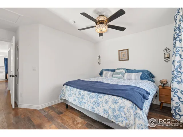 a bedroom with a bed and a ceiling fan