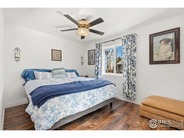 a bedroom with a bed and a painting on the wall