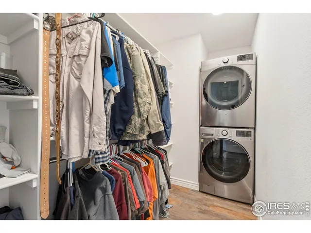 a view of walk in closet with clothes and shoes