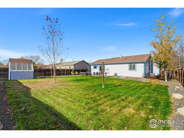 a view of a house with a backyard