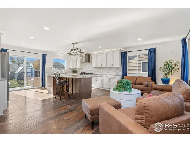 a living room with furniture and a kitchen view