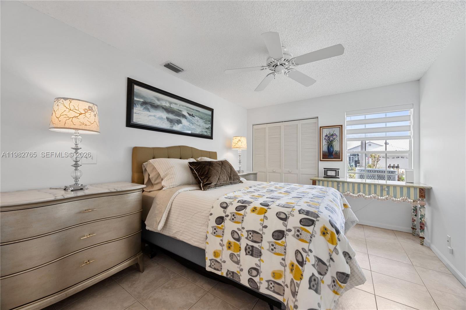 8962 Southeast Riverfront Terrace Jupiter, FL 33469 - Photo 11 of 20 a bedroom with a large bed and a window