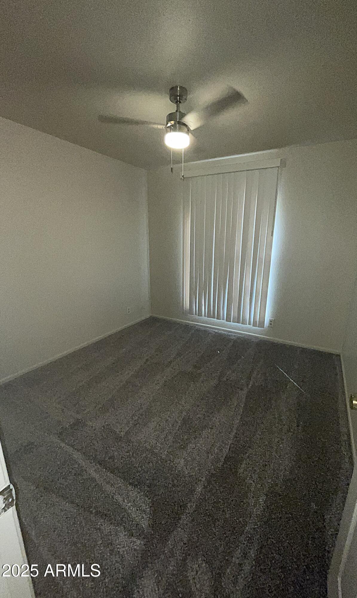 17811 North 29th Drive Phoenix, AZ 85053 - Photo 11 of 14 en empty room with windows and fan