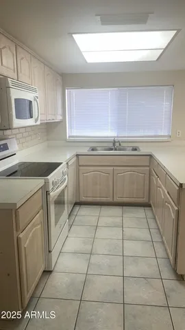 a kitchen with stainless steel appliances granite countertop a sink and cabinets
