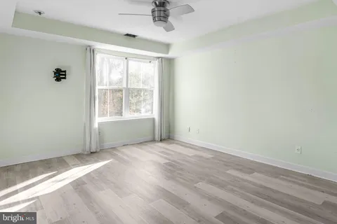 a view of a livingroom with a ceiling fan and entryway