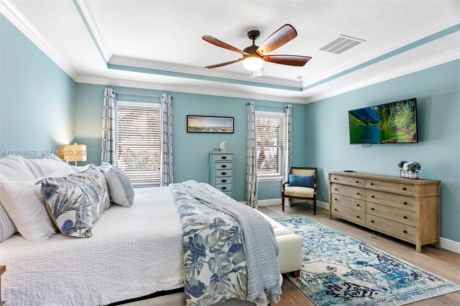 1773 Southwest Palermo Road Port St. Lucie, FL 34987 - Photo 16 of 50 Relax in spacious primary bedroom suite with trey ceilings, crown molding and views to pool/patio.