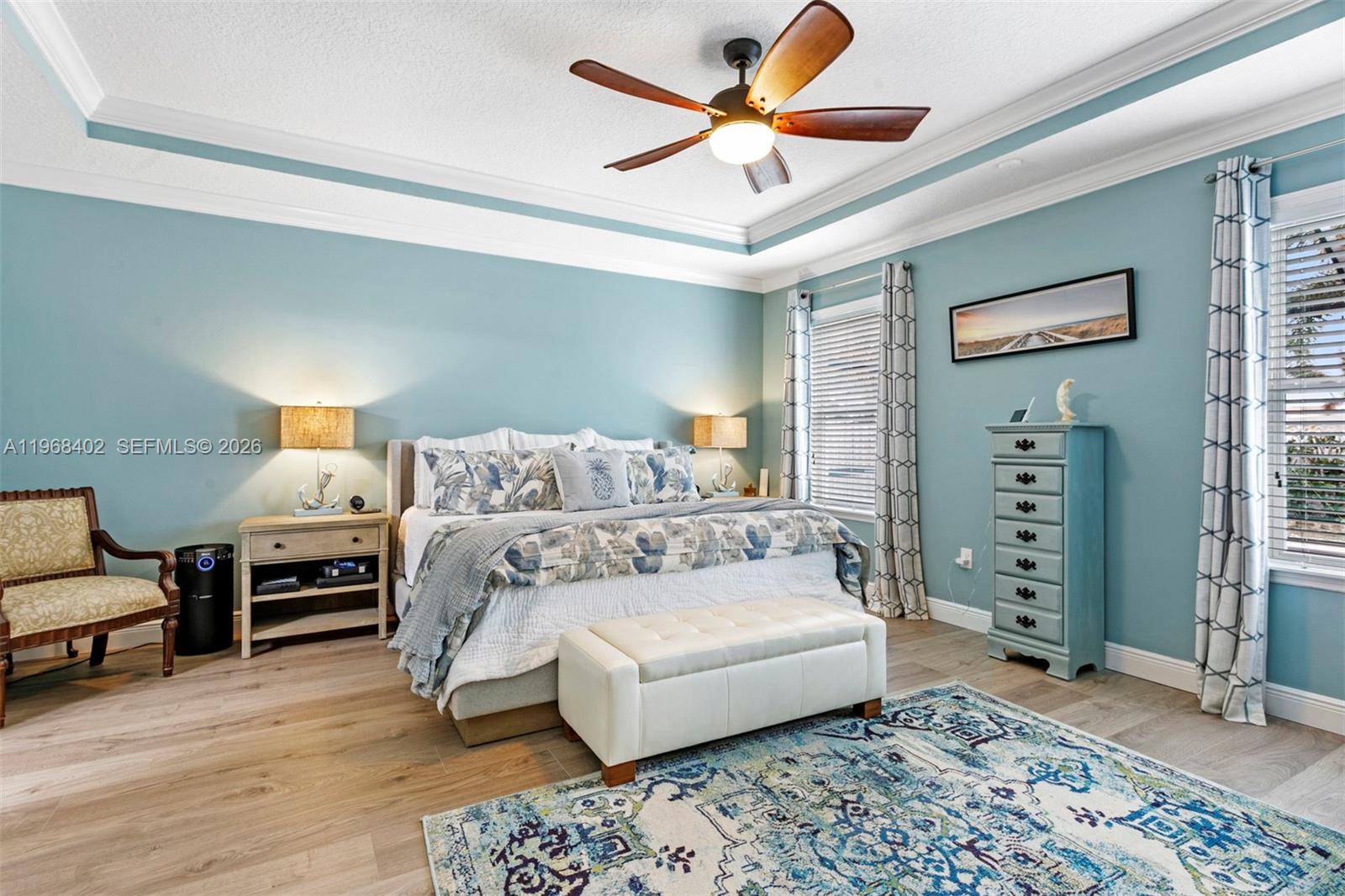 1773 Southwest Palermo Road Port St. Lucie, FL 34987 - Photo 17 of 50 Relax in the spacious primary bedroom suite with trey ceilings, crown molding and views to pool/patio.