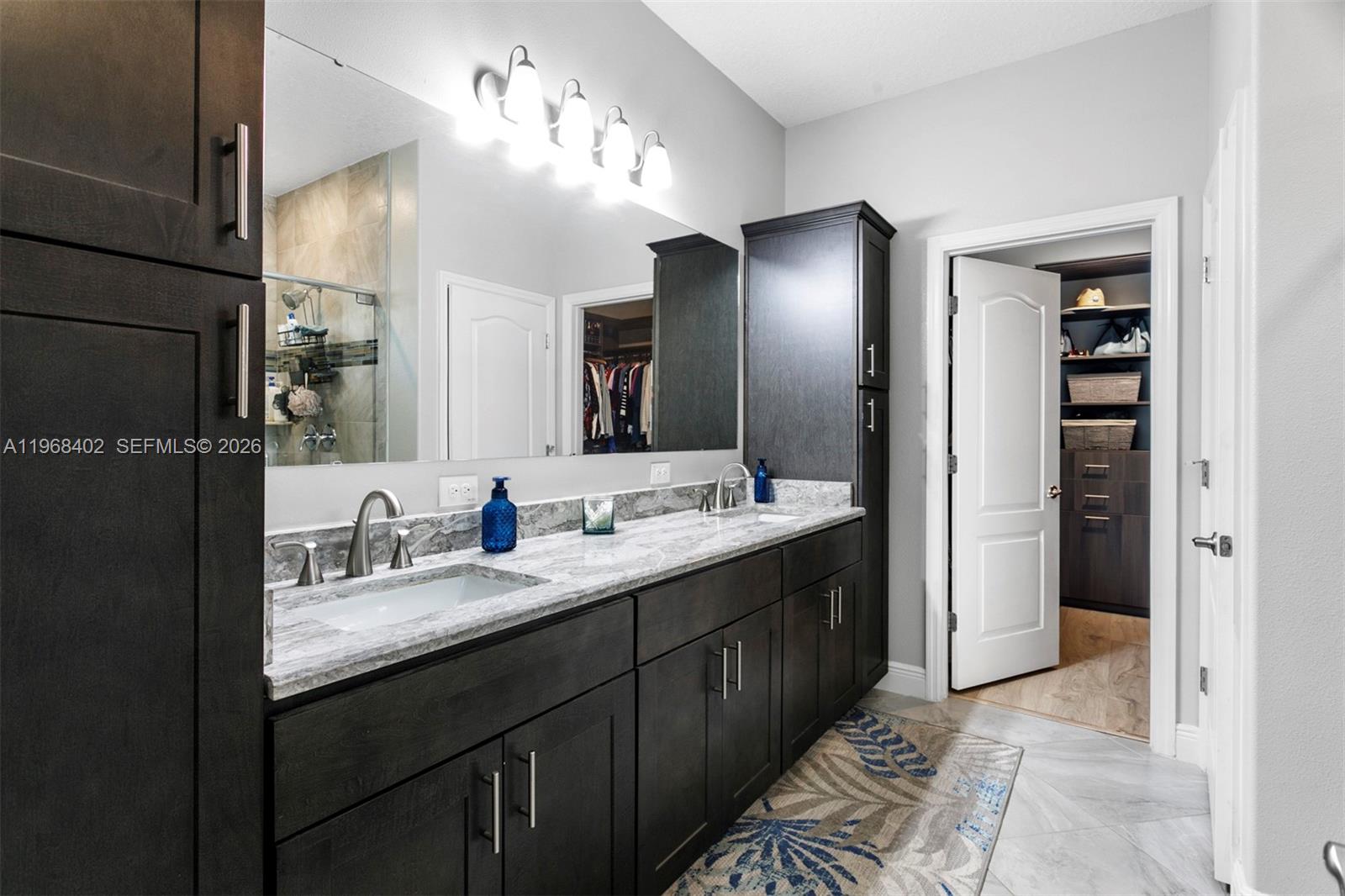 1773 Southwest Palermo Road Port St. Lucie, FL 34987 - Photo 18 of 50 Spa like Primary Bath with new Quartz tops, double sink, step in shower and large custom walk in closet!