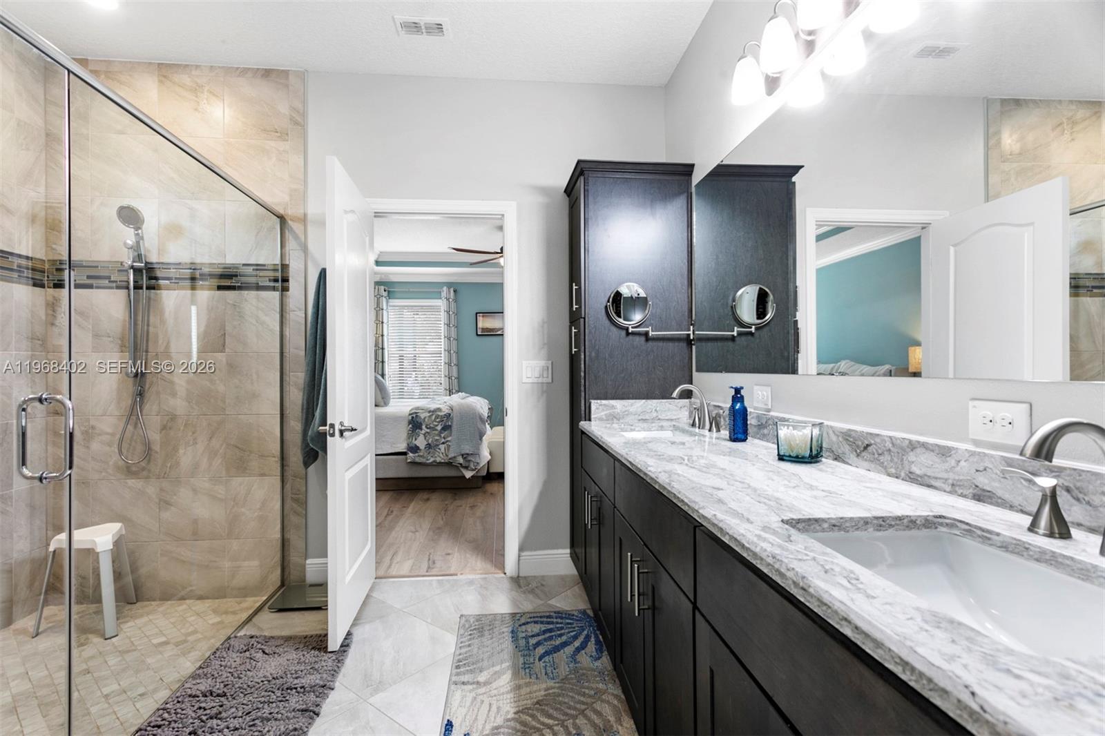 1773 Southwest Palermo Road Port St. Lucie, FL 34987 - Photo 19 of 50 Spa like Primary Bath with new Quartz tops, double sink, step in shower and large custom walk in closet!