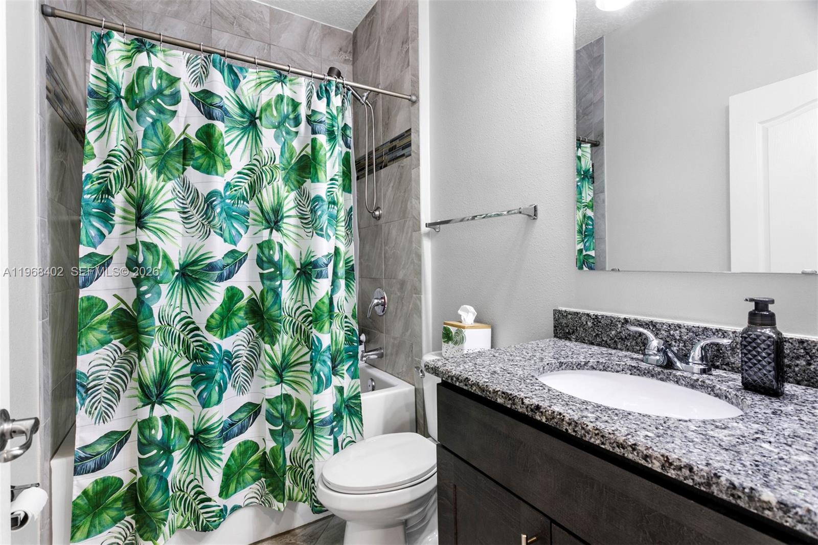 1773 Southwest Palermo Road Port St. Lucie, FL 34987 - Photo 23 of 50 Bath 2 - shower/tub combo, custom tiled shower, granite cabinetry, laminate flooring.
