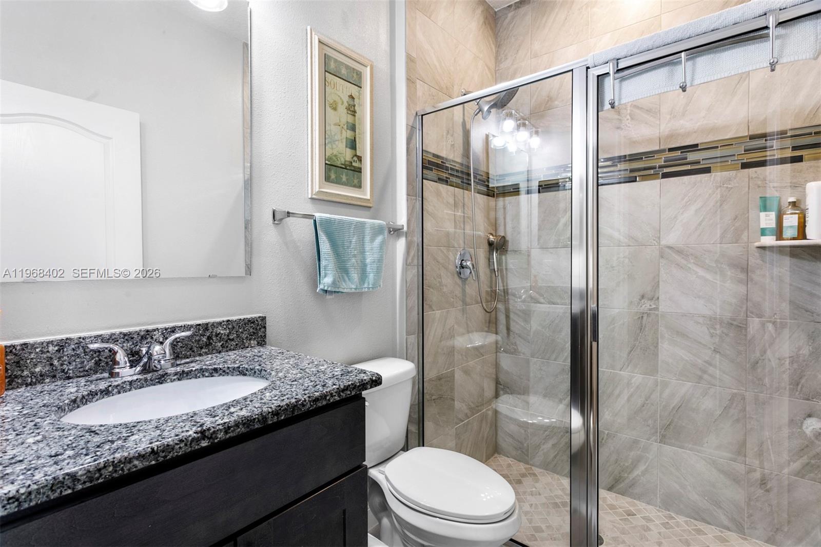 1773 Southwest Palermo Road Port St. Lucie, FL 34987 - Photo 25 of 50 Bath 3 - custom tiled step in shower, granite top cabinetry.