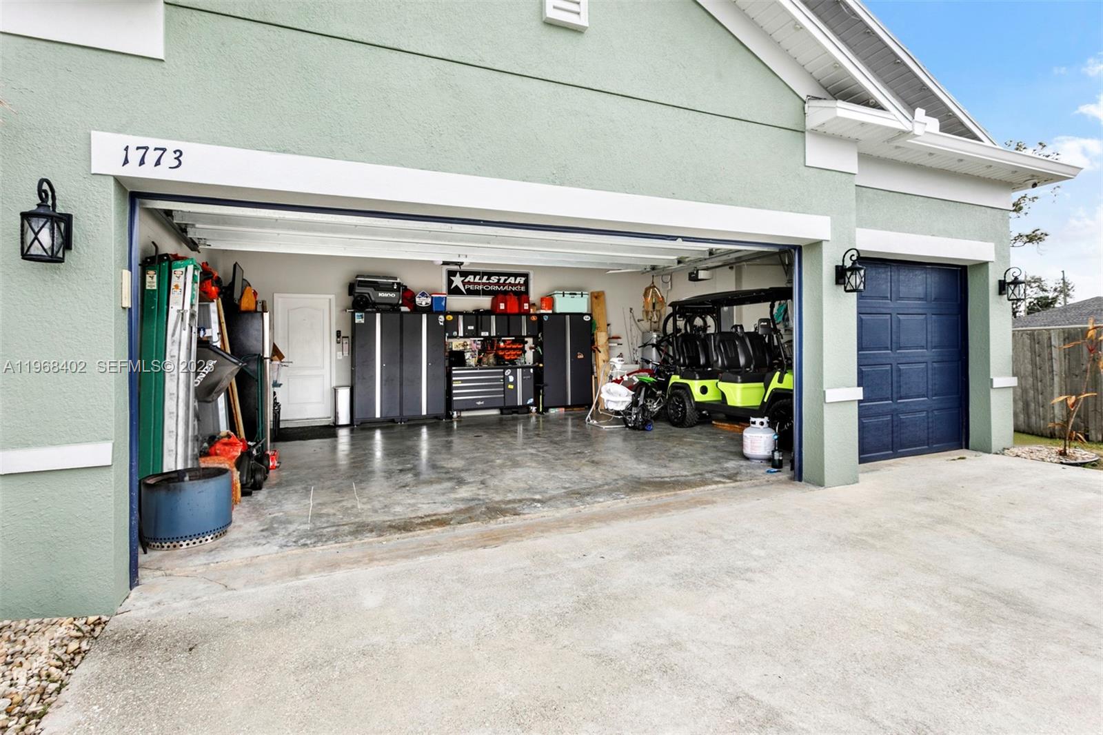1773 Southwest Palermo Road Port St. Lucie, FL 34987 - Photo 6 of 50 3 car garage, with built ins and refrigerator. Golf Cart is negotiable!