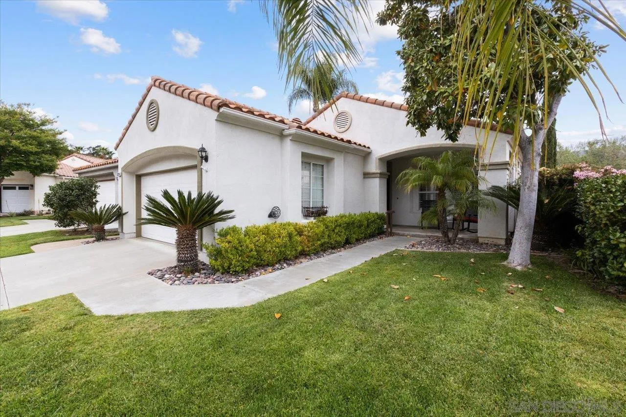 a view of a house with a yard and plants